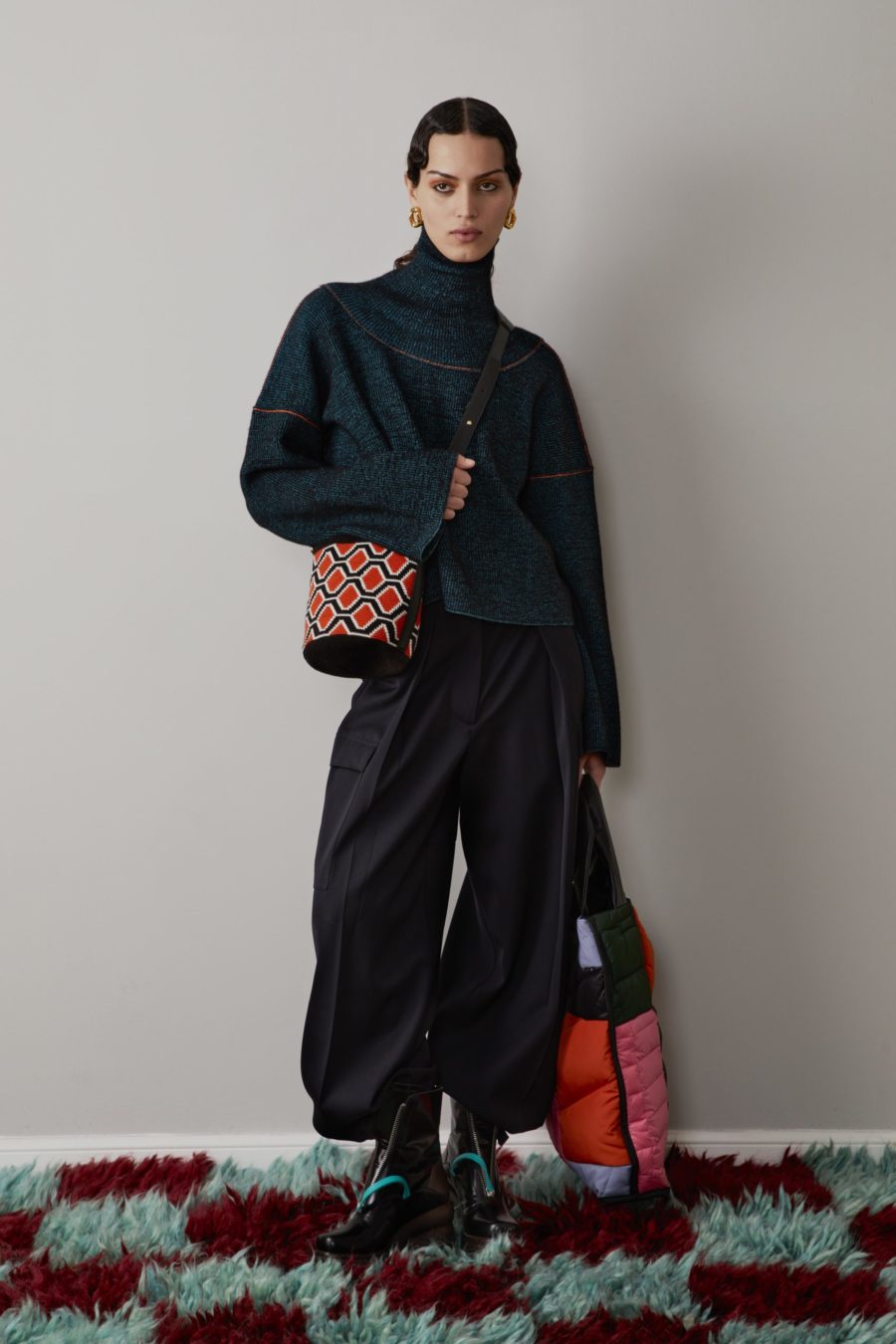 AW22 Colville. Teal turtleneck with print bag. with Multi-color bag. The fashion stalwarts, Lucinda Chambers and Molly Molloy of Colville, on crafting thoughtful, eclectic pieces designed to make an impact.