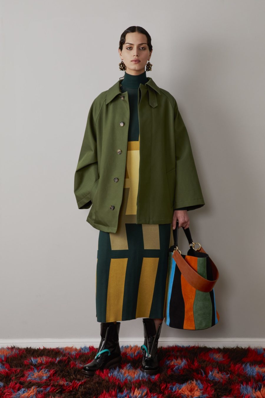 AW22 Colville. Green Jacket. with Multi-color bag. The fashion stalwarts, Lucinda Chambers and Molly Molloy of Colville, on crafting thoughtful, eclectic pieces designed to make an impact.