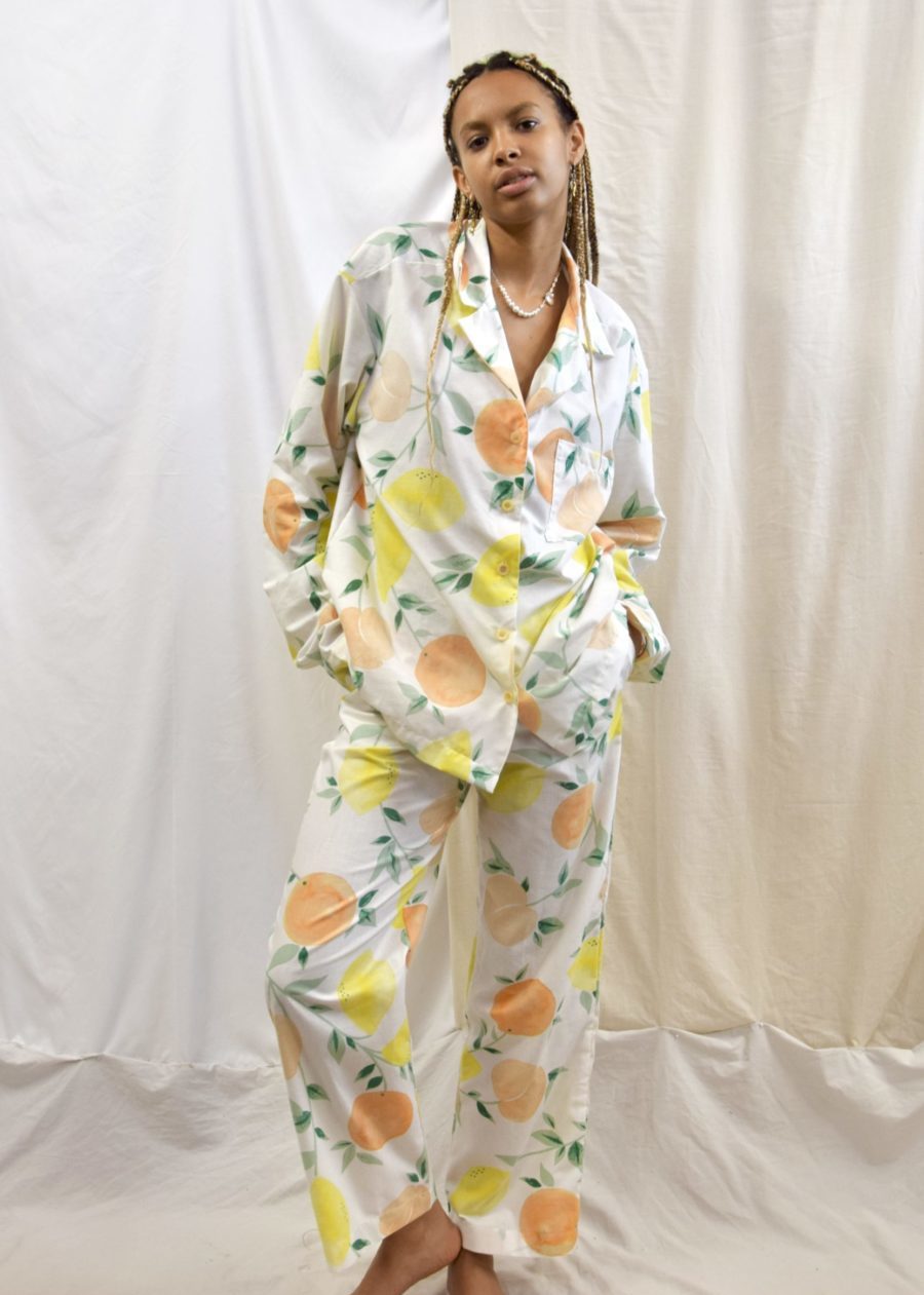 Woman wearing a white pyjama with lemons and oranges