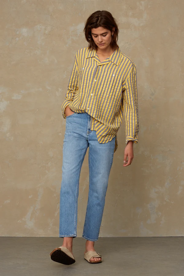 woman wearing jeans and yellow shirt