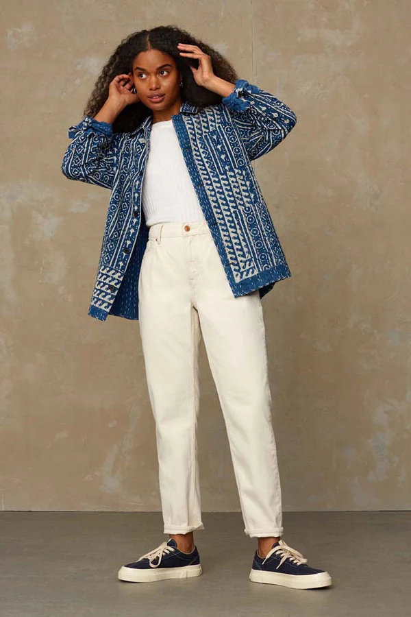 woman wearing white jeans and blue jacket