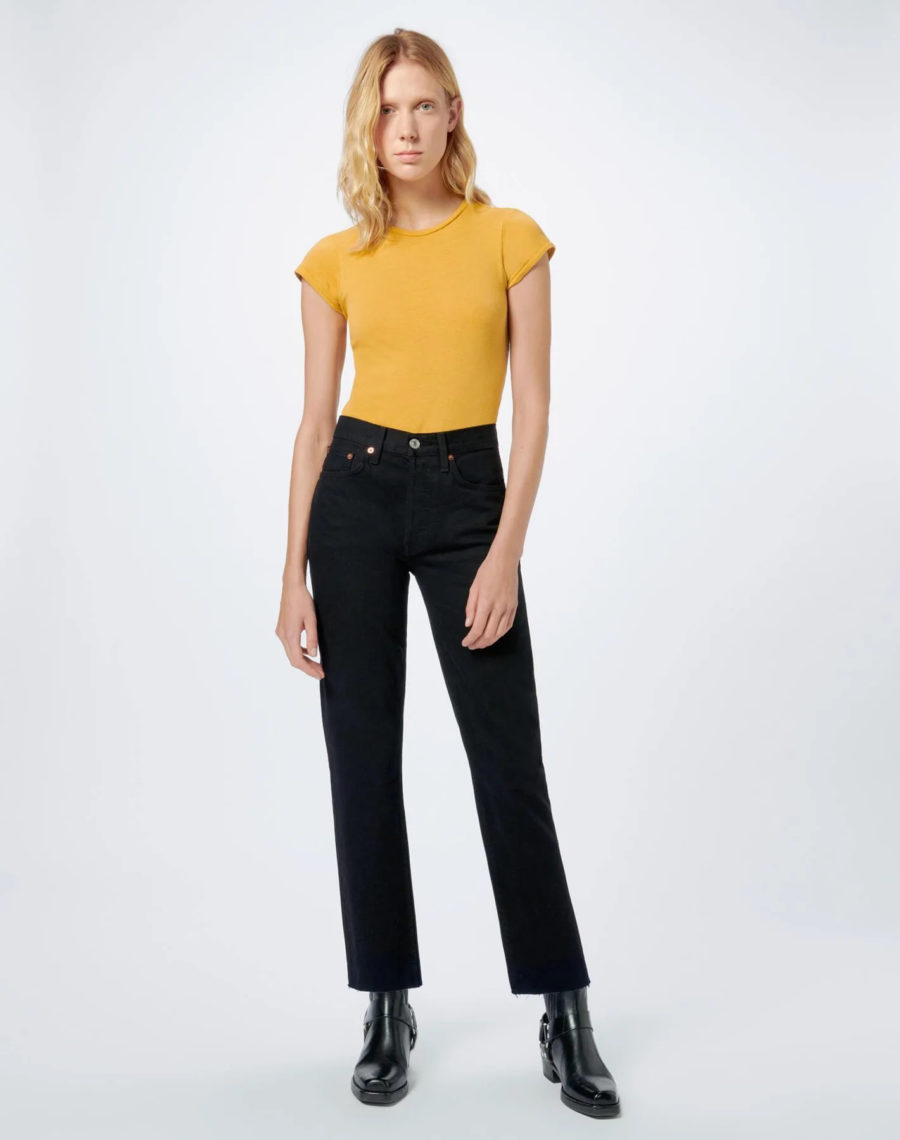 woman wearing black jeans and yellow t-shirt
